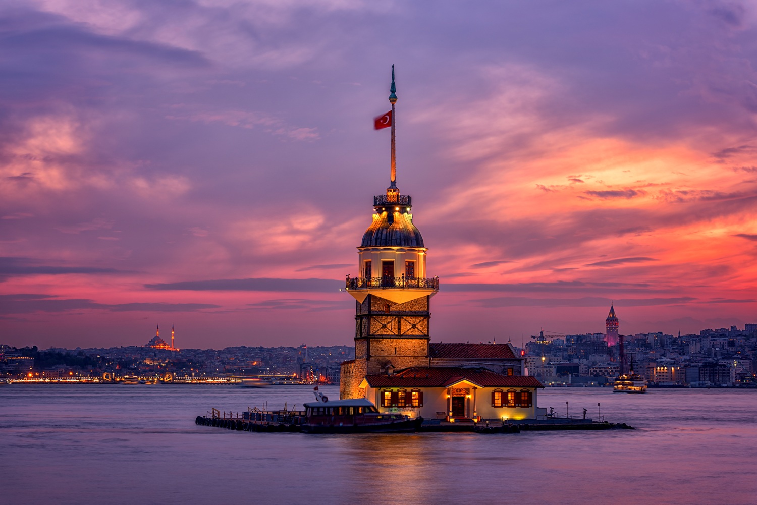 Fiery sunset over Bosphorus with famous Maiden's Tower (Kiz Kulesi) also known as Leander's Tower, symbol of Istanbul, Turkey. Scenic travel background for wallpaper or guide book