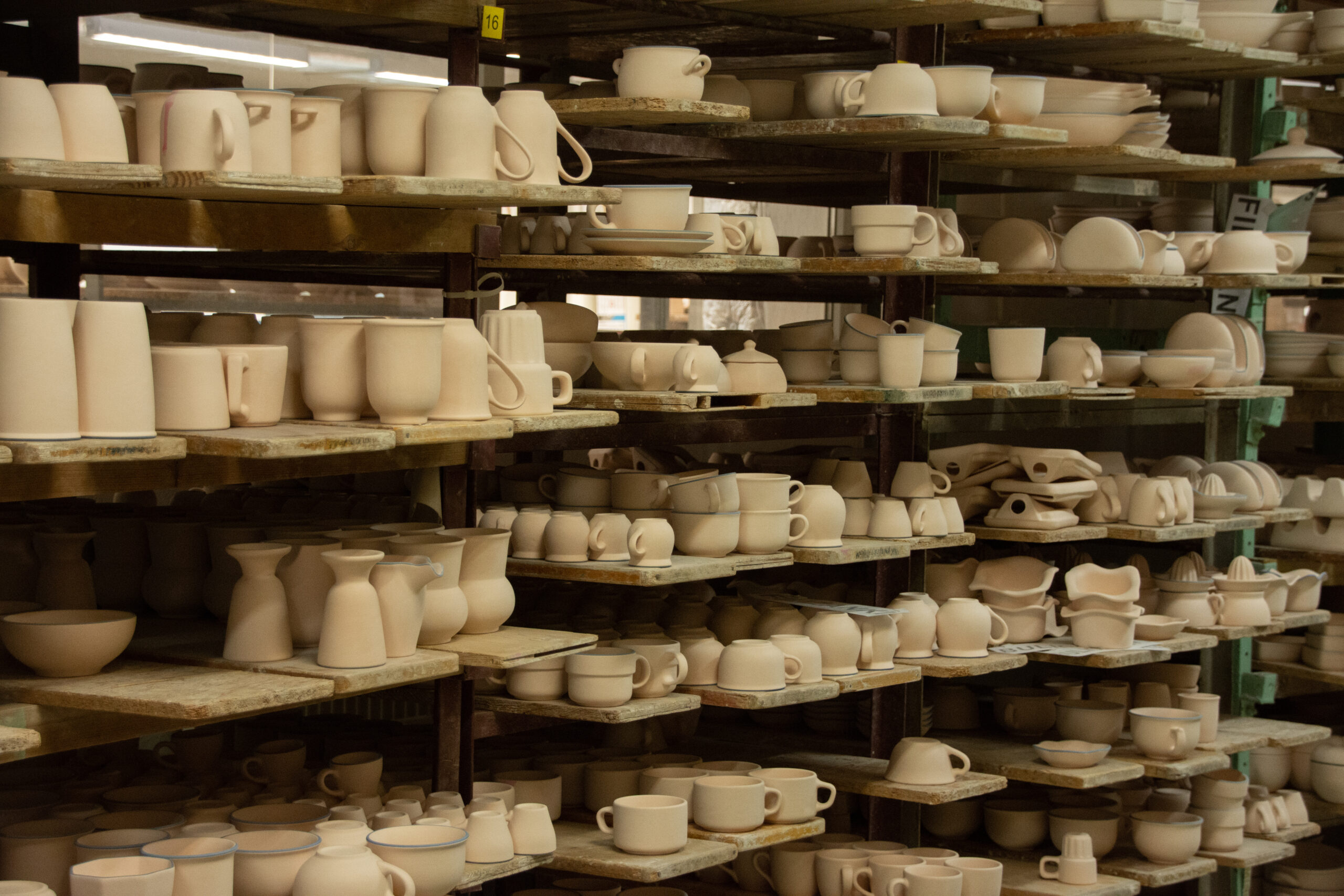 Unique handcrafted ceramic jugs and mugs before firing
