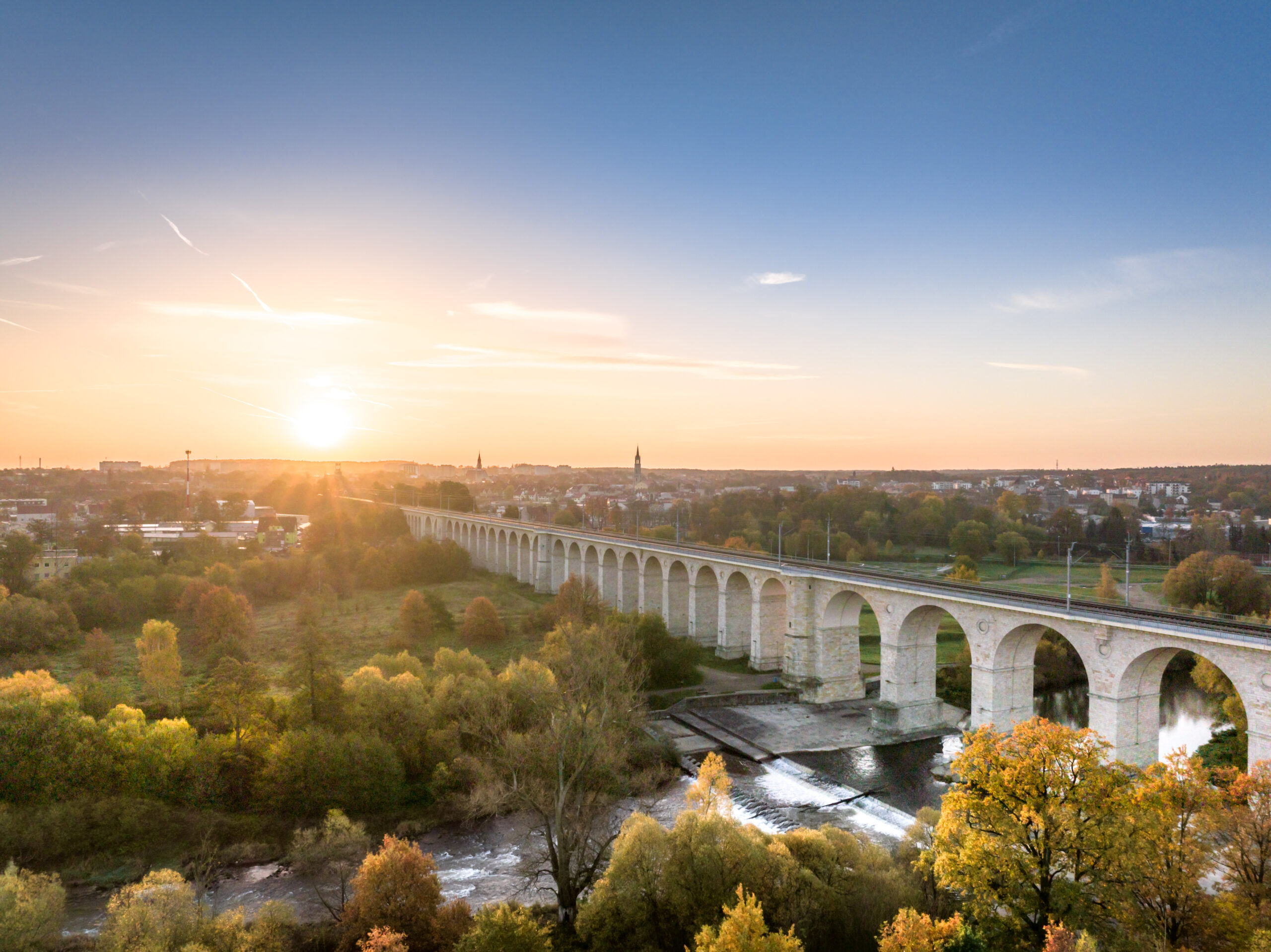A unique autumn aerial shot of a rail bridge (wiadukt kolejowy) in Boleslawiec, Poland at sunrise.